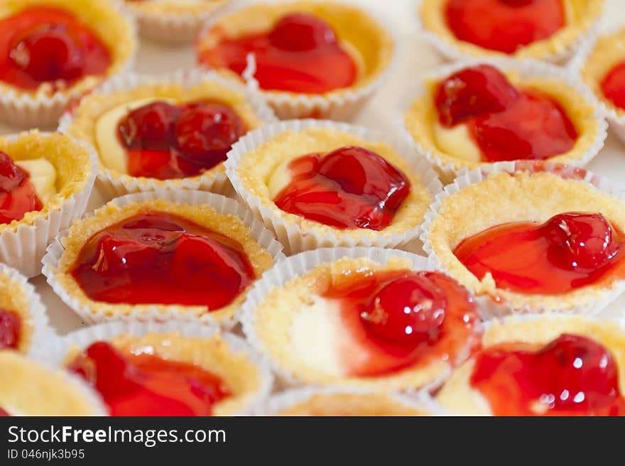 Red Cherry pie in small cup of zigzag edge on white plate