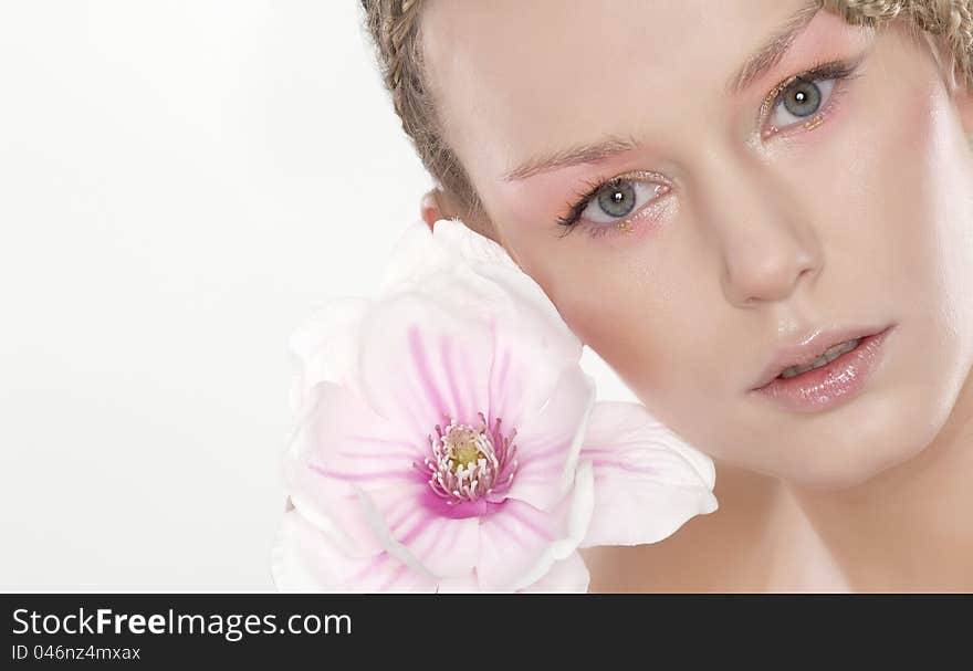 Portrait of beautiful young woman with lily flower. Isolated on white background