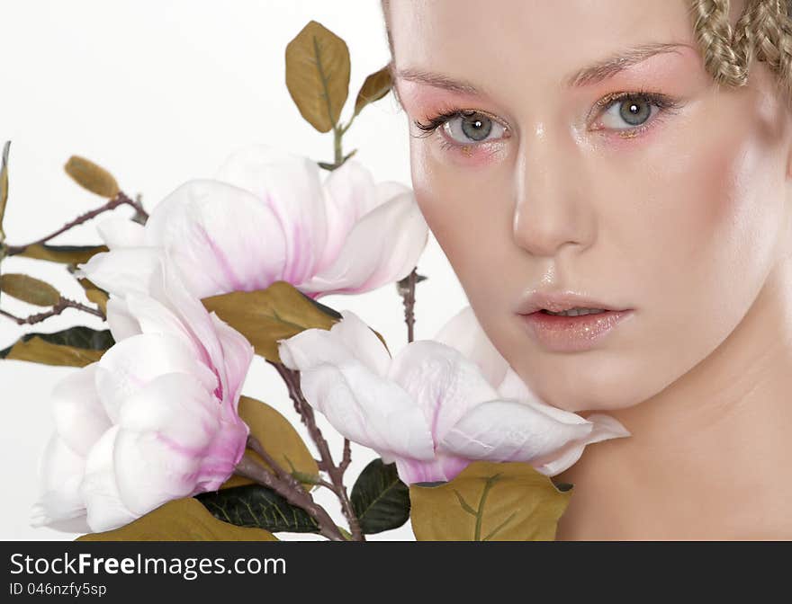 Portrait of beautiful young woman with lily flower. Isolated on white background