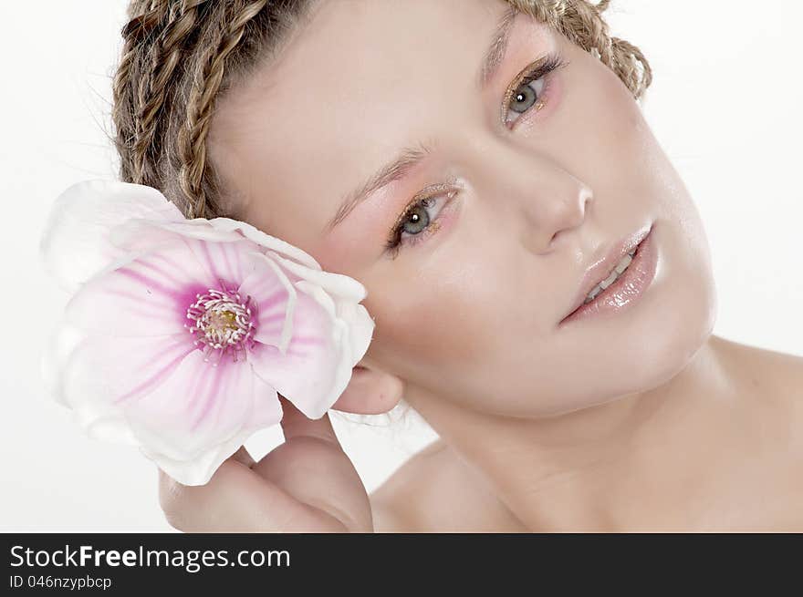 Portrait of beautiful young woman with lily flower. Isolated on white background