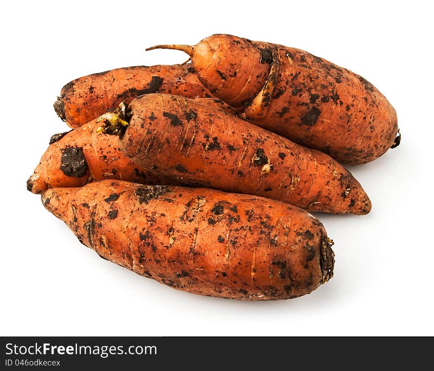 Muddy carrot heap against white background