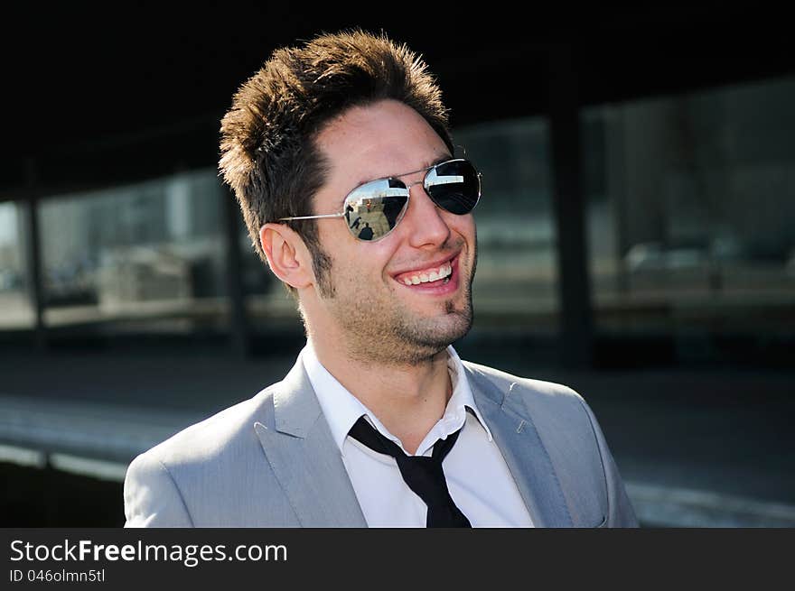 Portrait of a handsome young businessman laughing