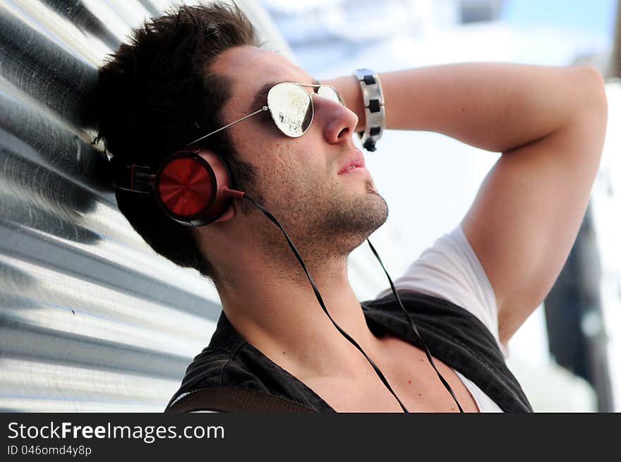 Portrait of young happy man in urban background. Portrait of young happy man in urban background