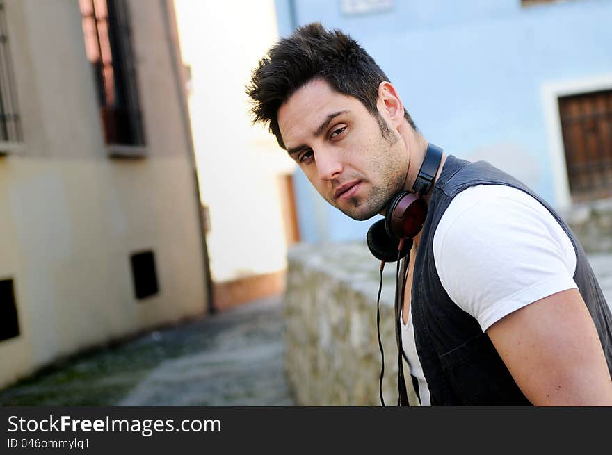 Portrait of young attractive man in urban background. Portrait of young attractive man in urban background