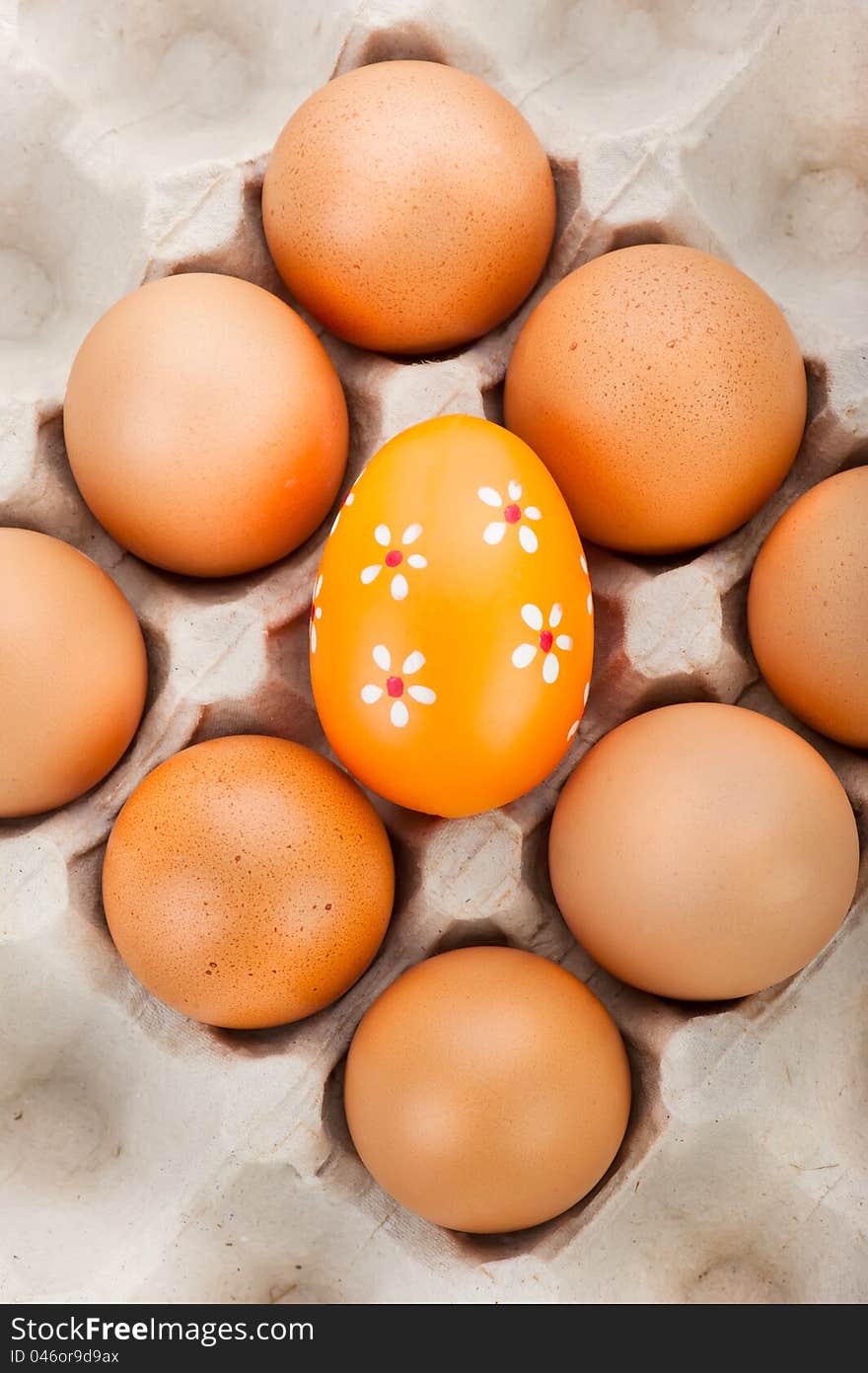 Easter background. Eggs in cardboard container and one painted easter eggs. Easter background. Eggs in cardboard container and one painted easter eggs