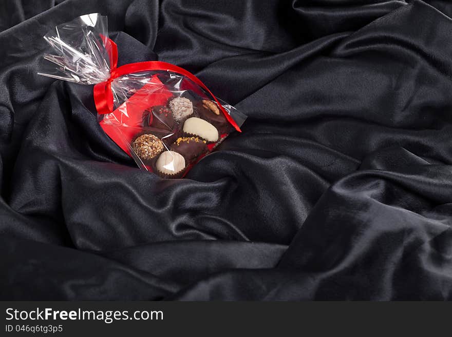 Transparent Bag With Chocolates On Black