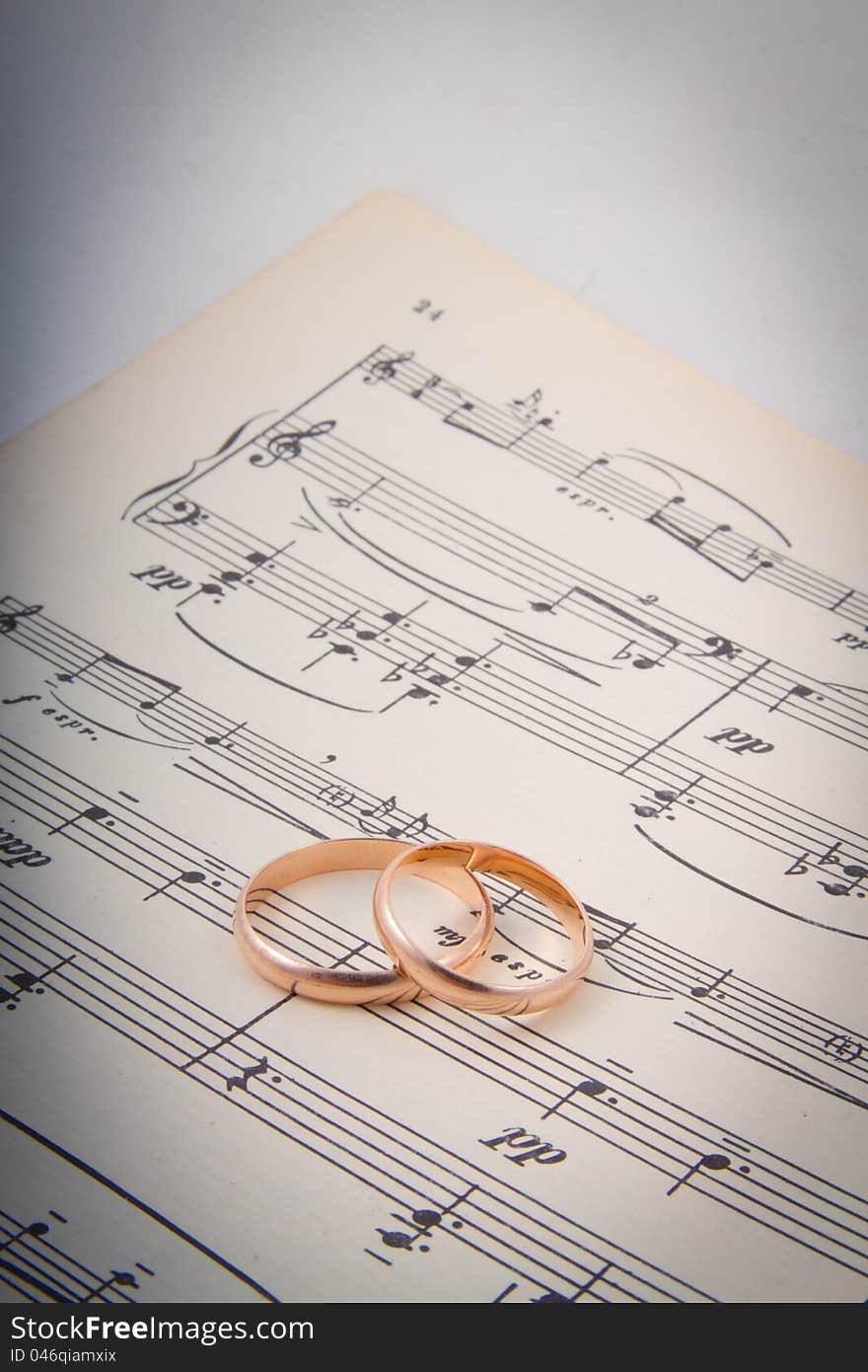 Wedding rings on the notes.music hearts