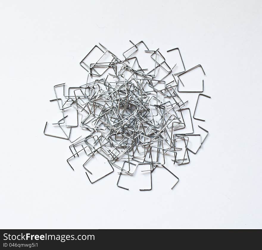 Staples scattered on a white surface. Staples scattered on a white surface