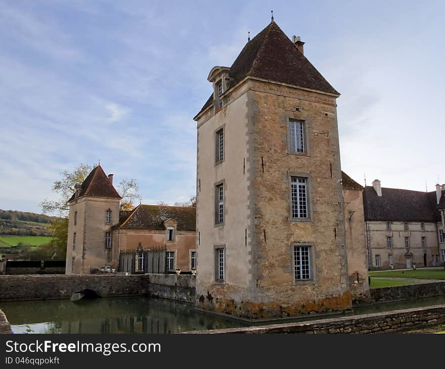 The chateau de Commarin (castle) is located in Burgundy, France. The castle is moated, surrounded by water.