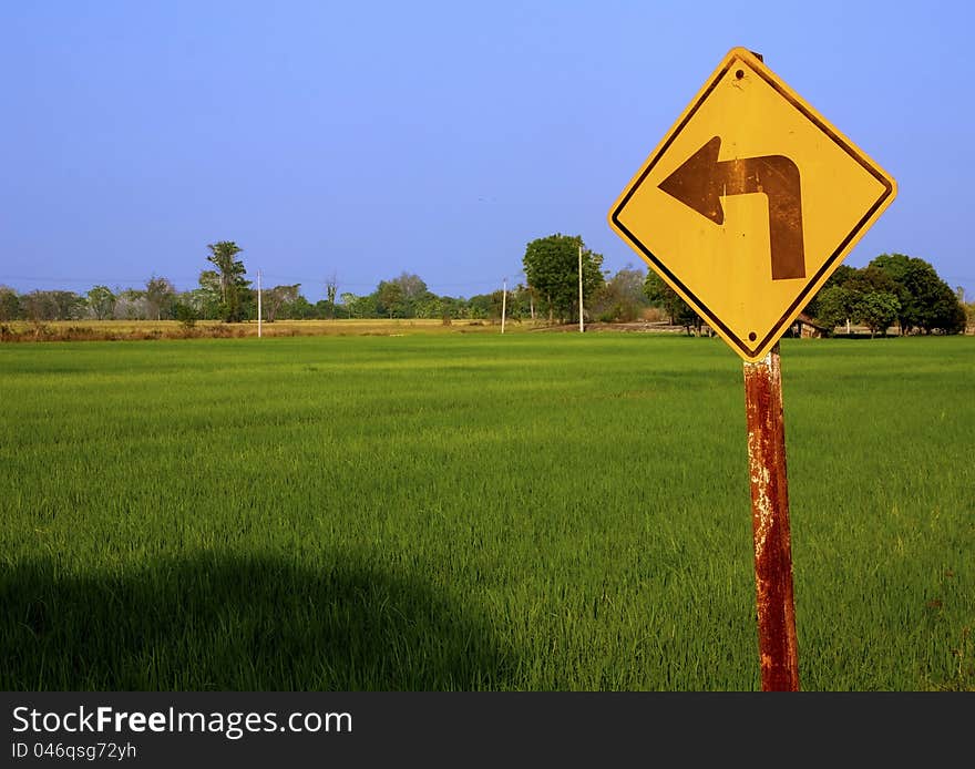 Rice field with turn left sign in countryside. Rice field with turn left sign in countryside