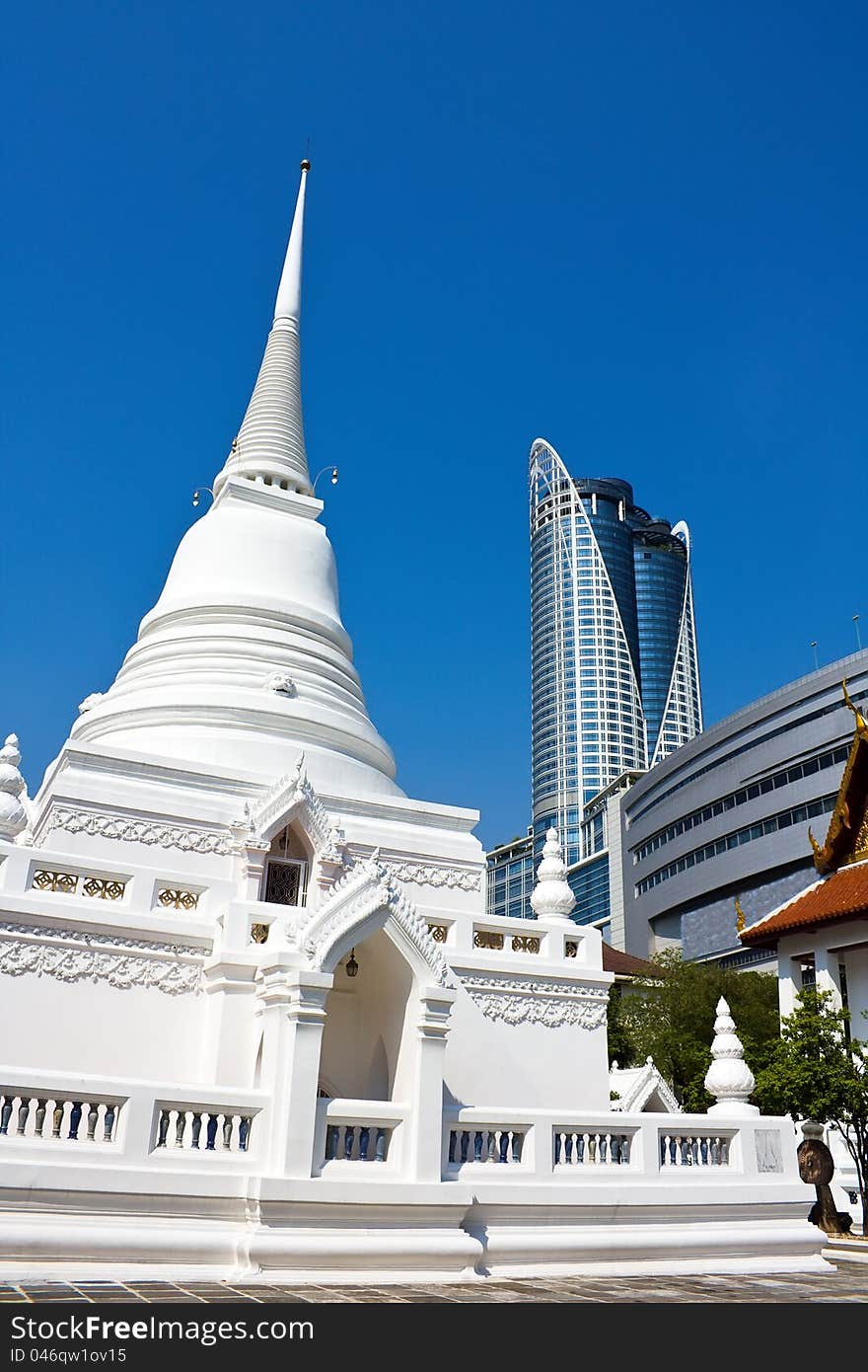 Temple versus modern shopping building in Bangkok