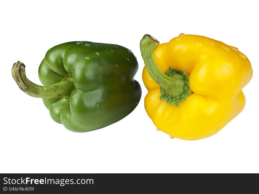 Green and yellow paprica with droplet on a white background