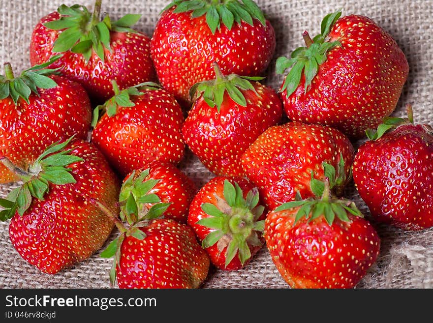 Fresh strawberies on bagging material bckground. Fresh strawberies on bagging material bckground