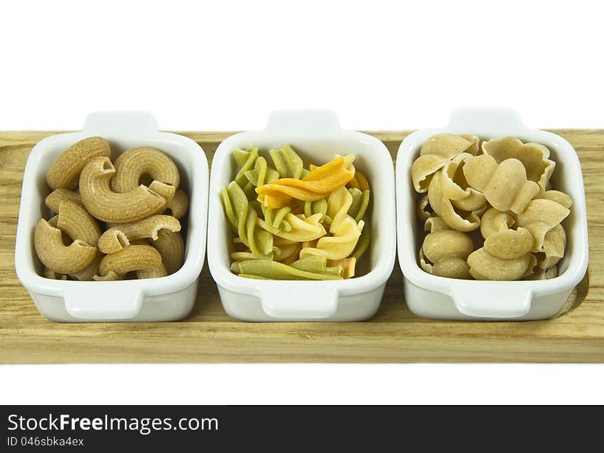 Three sorts of uncooked pasta in a ceramic dishes. Three sorts of uncooked pasta in a ceramic dishes