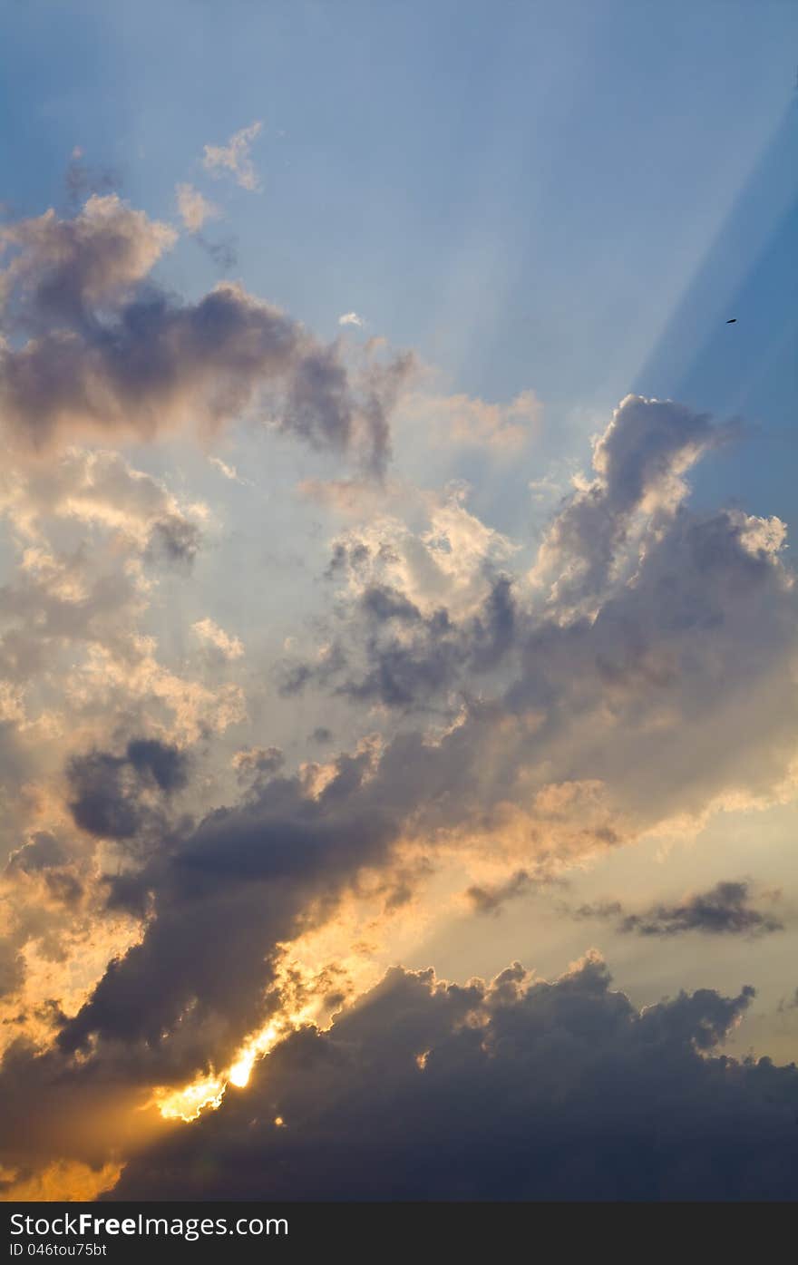 Sunset sky after a thunderstorm with the rays of a sun