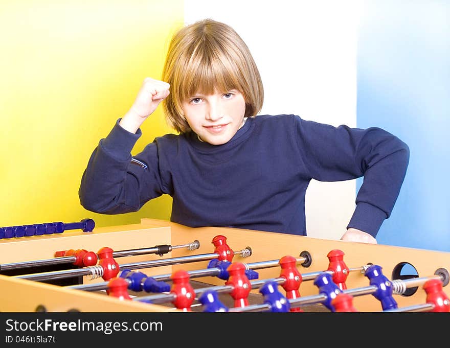 Winner young boy playing table football