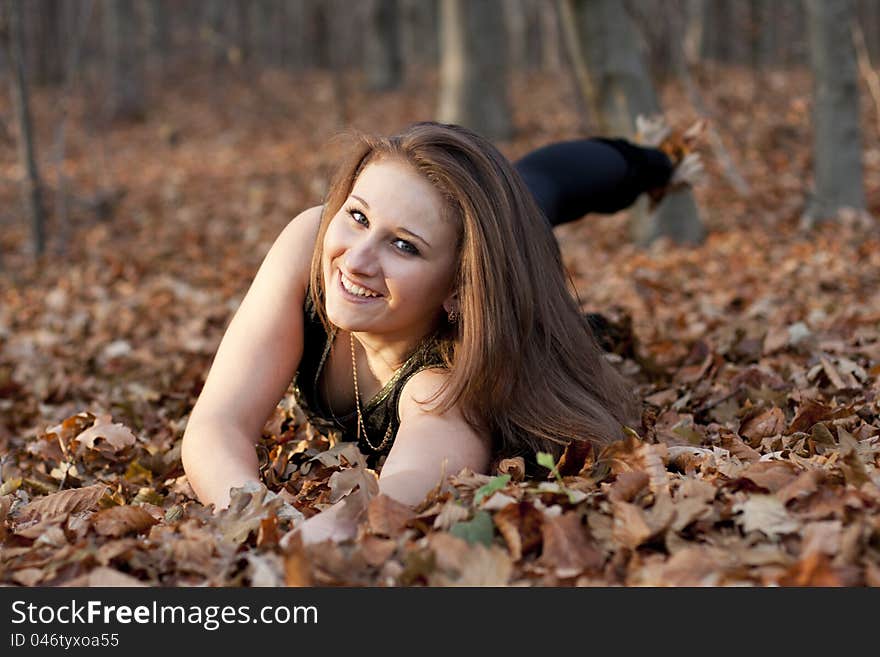 Girl on a background of brown leaf. Girl on a background of brown leaf