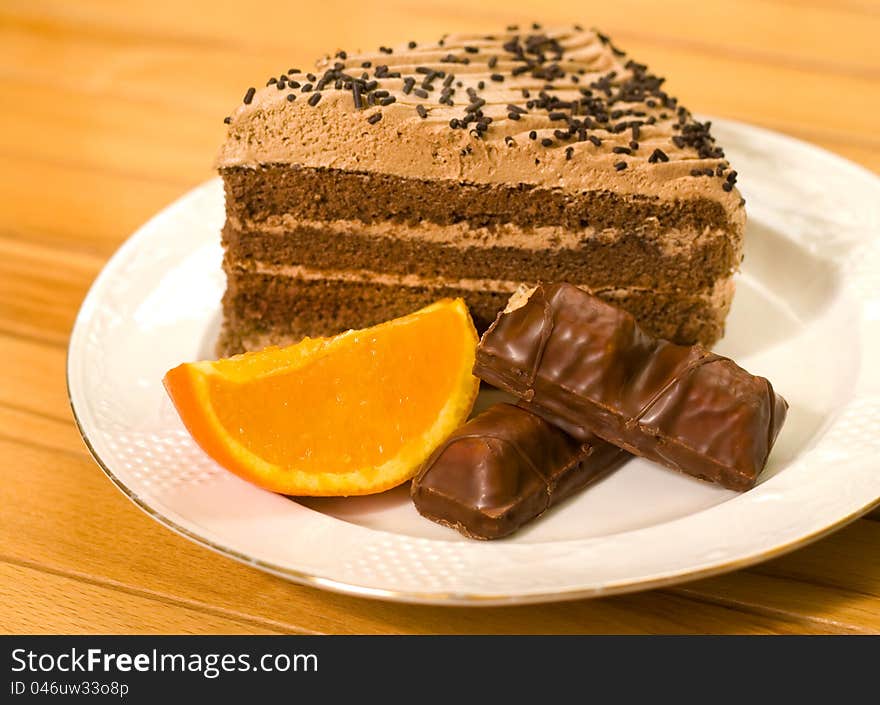 Chocolate cake being sliced orange