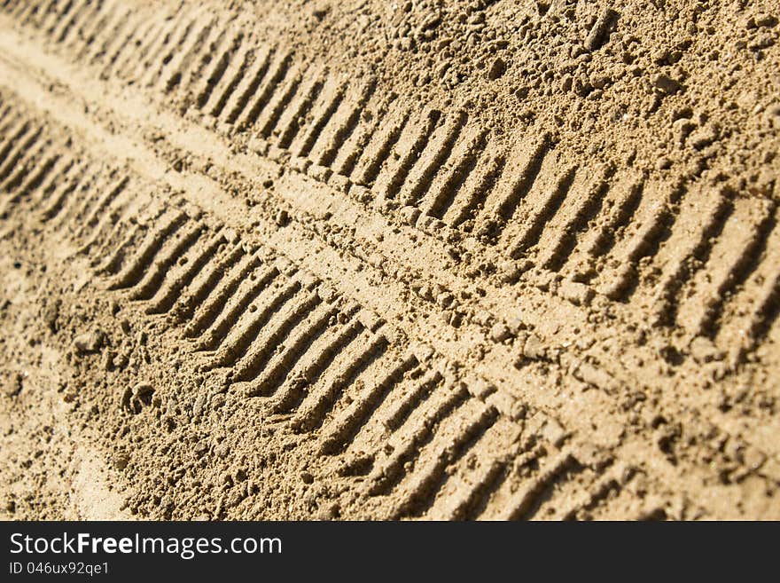 Tire tracks in the sand left by a car. Tire tracks in the sand left by a car