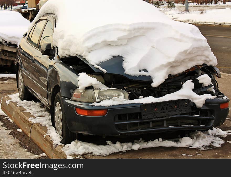 Car after accident left by it's owner and is in the weather covered with snow. Car after accident left by it's owner and is in the weather covered with snow