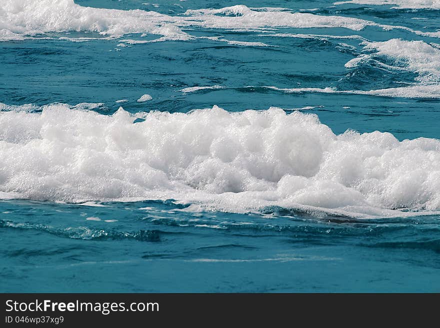 White foam on a sea water surface. White foam on a sea water surface