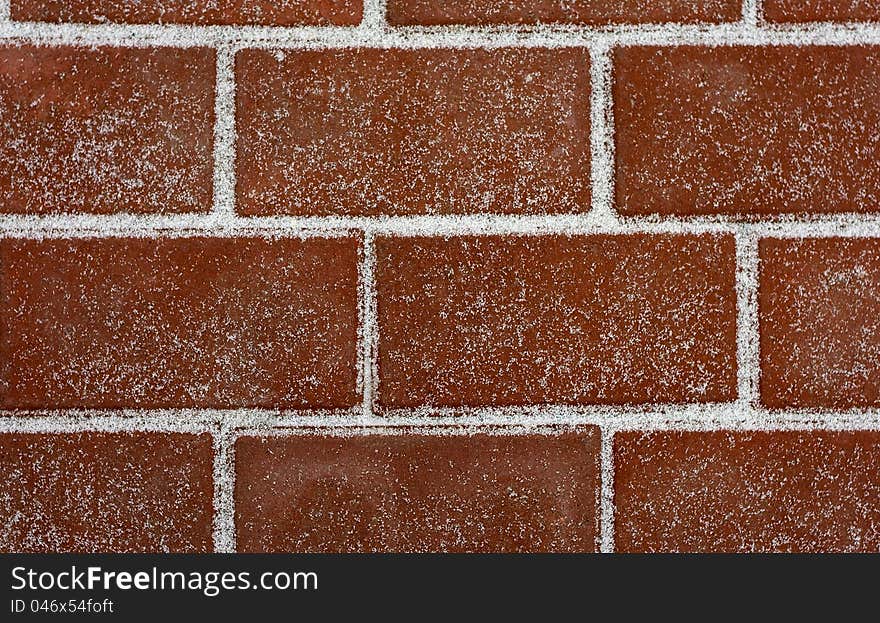 Brick masonry covered with snow. . Brick masonry covered with snow.