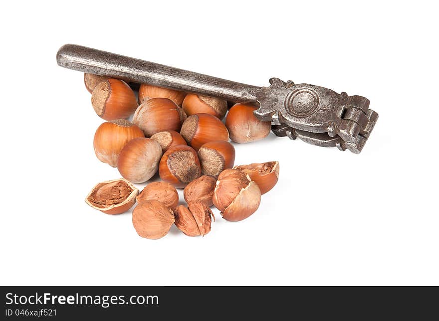 Nutcracker and cracked nuts on white background. Nutcracker and cracked nuts on white background