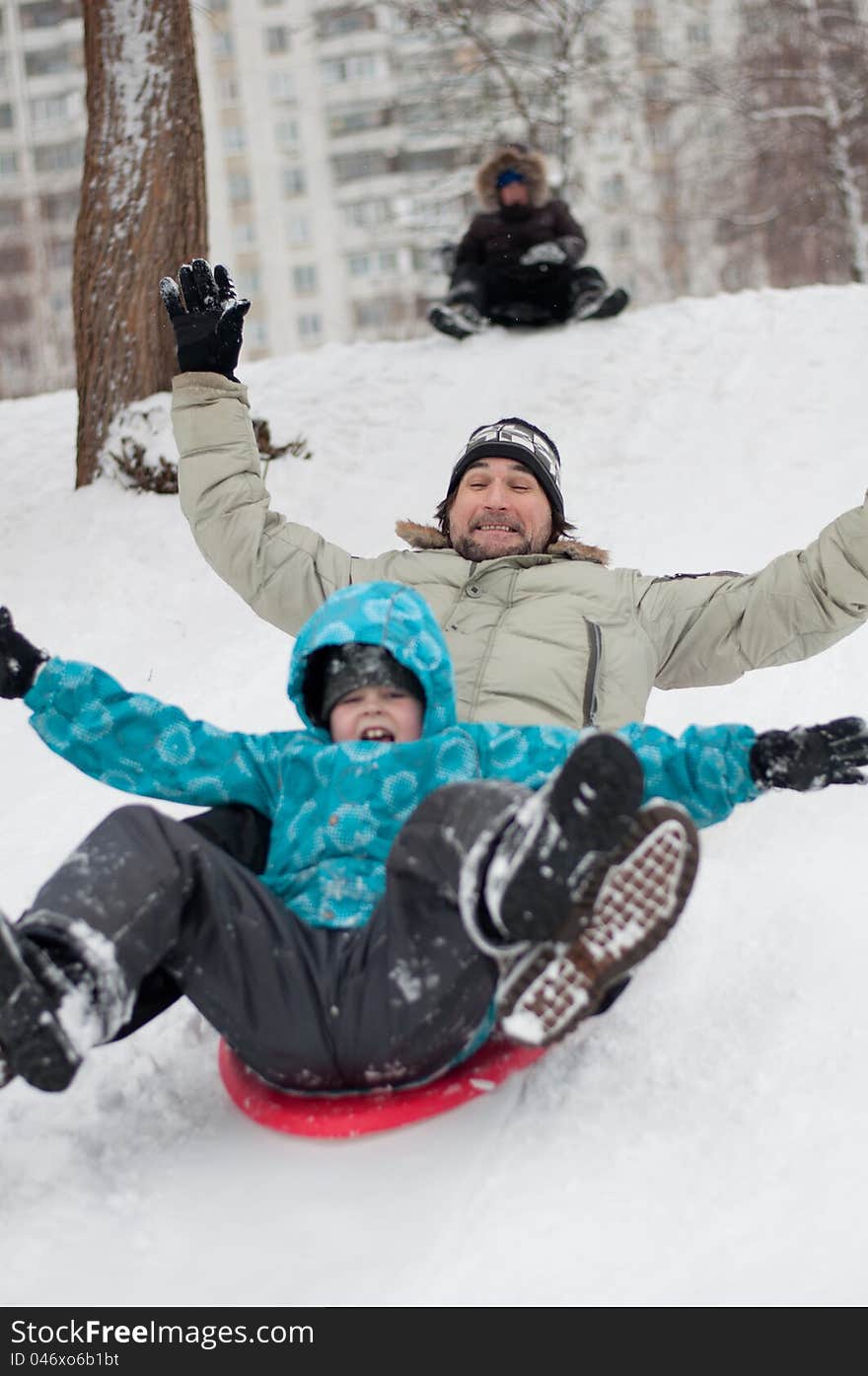 Dad And Son Riding From Frozen Hill