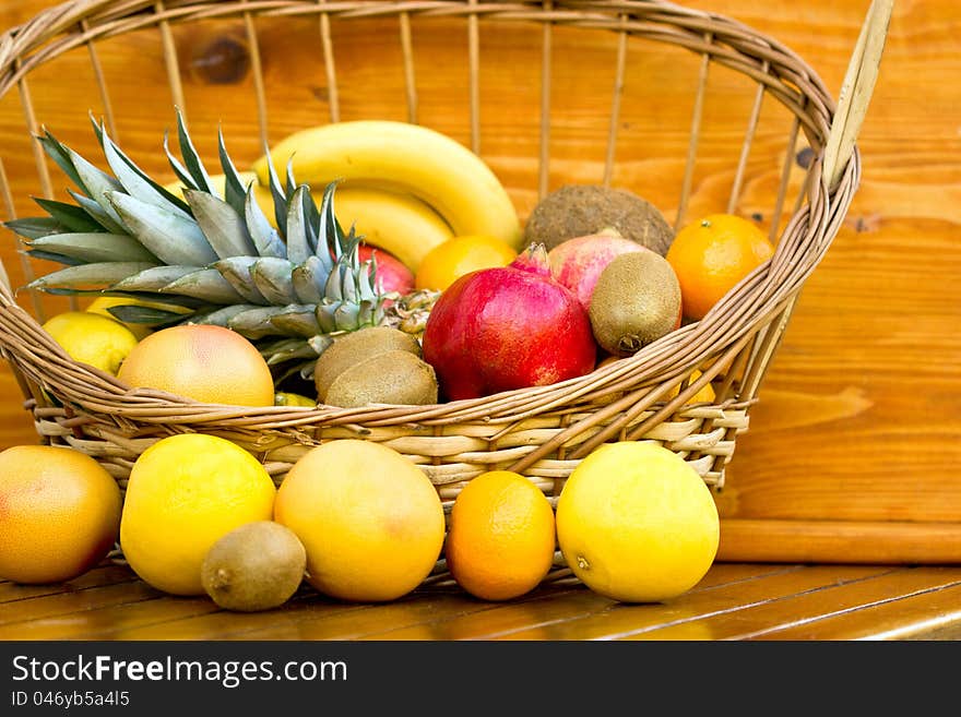 Tropical fruits in the wicker basket on the table