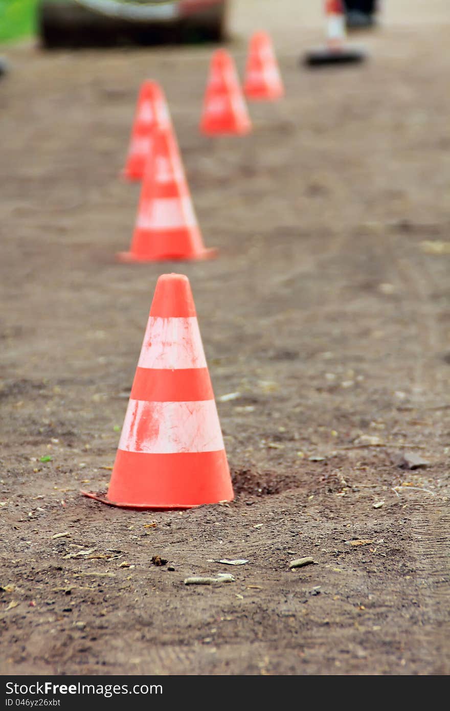 Traffic cones on the sandy road