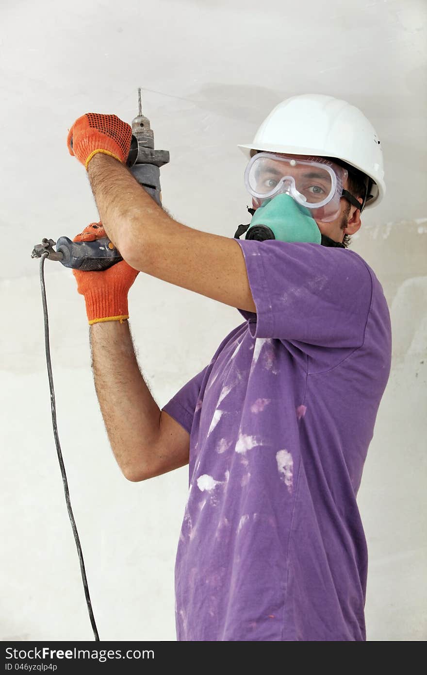 Handyman in a hardhat holding drill. Handyman in a hardhat holding drill