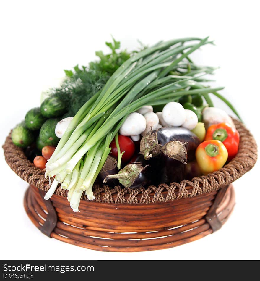 Basket of fresh vegetables isolated on white. Basket of fresh vegetables isolated on white