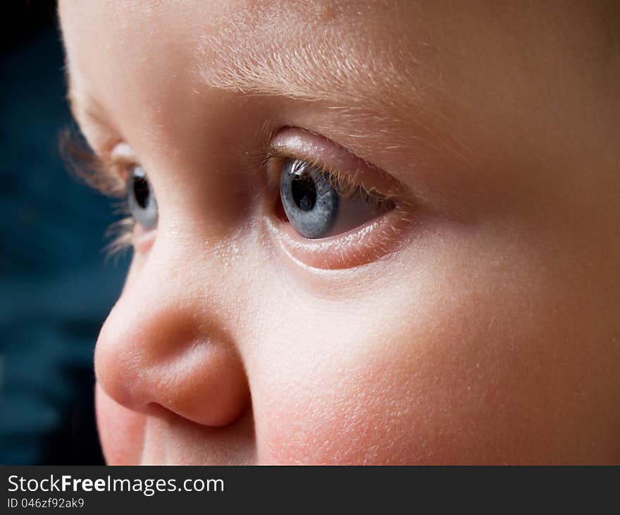 Baby Face with piercing blue eyes in profile. Baby Face with piercing blue eyes in profile