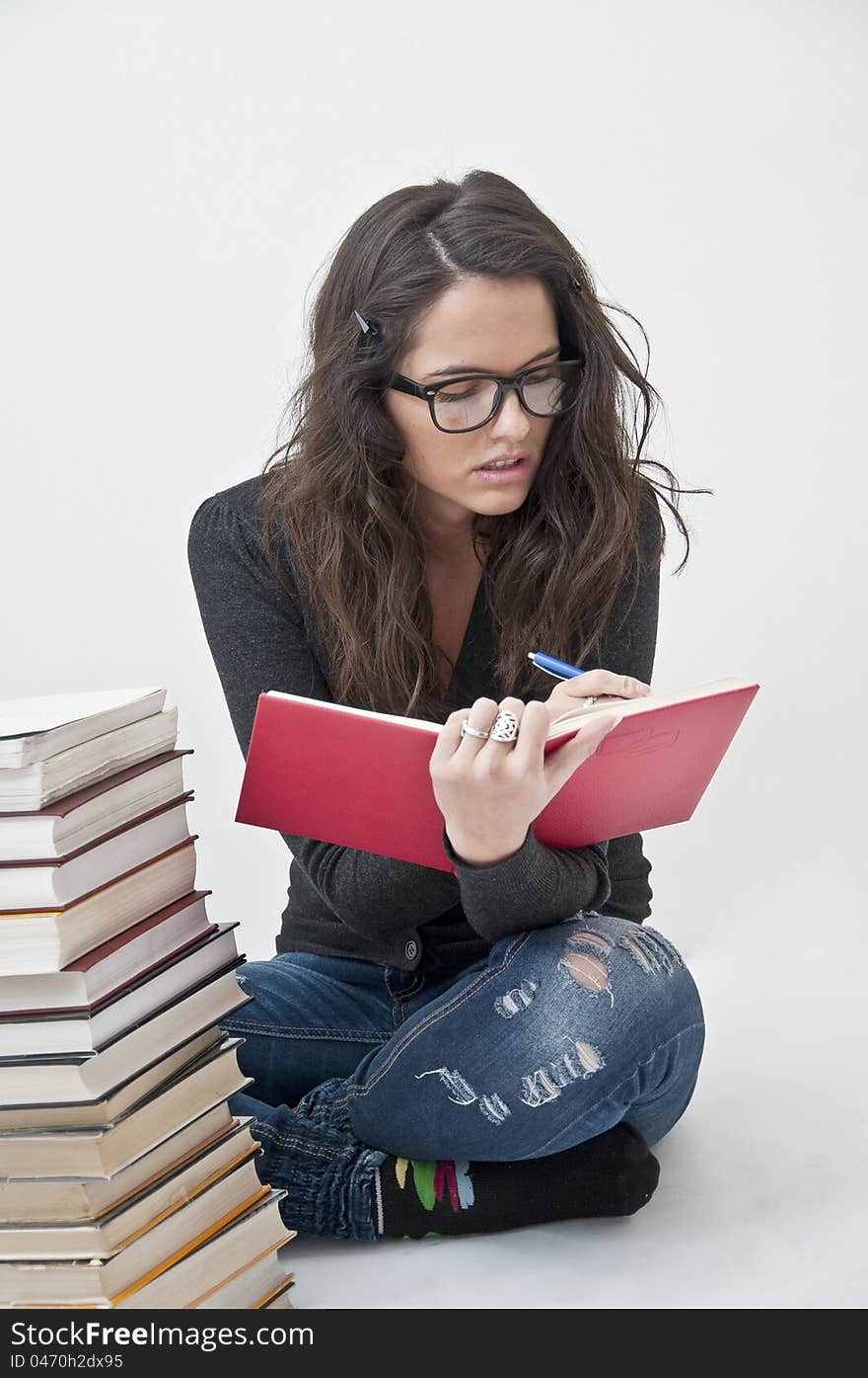 Student girl learning photographed with books, white background