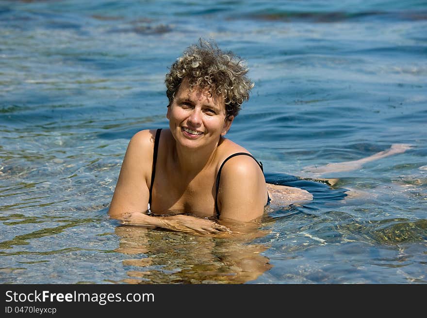 Portrait of a woman lying in the surf. Portrait of a woman lying in the surf