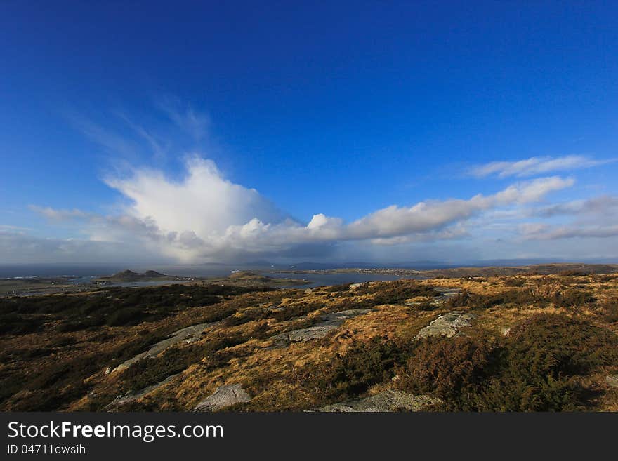 Rainclouds over an Island, seen from the island of Klosteroy, close to Stavanger, Norway