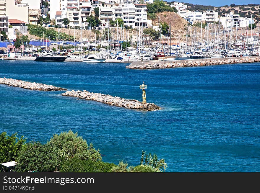 A small town on the sun-lit beach. In its harbor is a lot of yachts and boats. Today is a good day and they will come out into the sea. A small town on the sun-lit beach. In its harbor is a lot of yachts and boats. Today is a good day and they will come out into the sea.