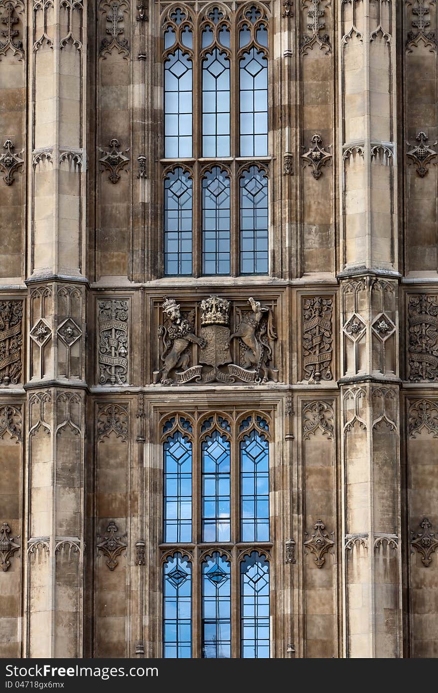 Building facade with windows and carvings, part of the House of Parliament in London. Building facade with windows and carvings, part of the House of Parliament in London.