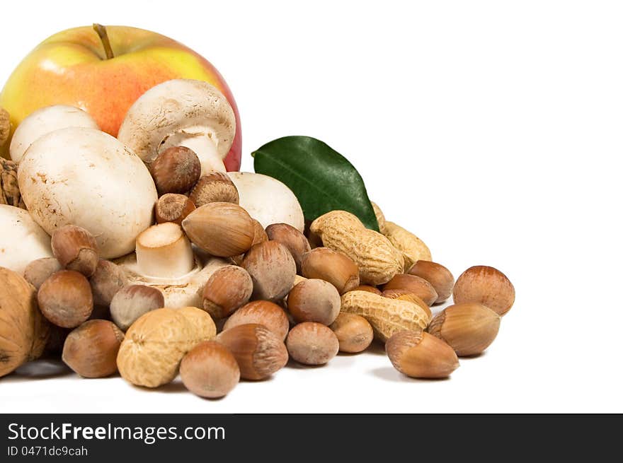 Apple, nuts and mushrooms on a white background