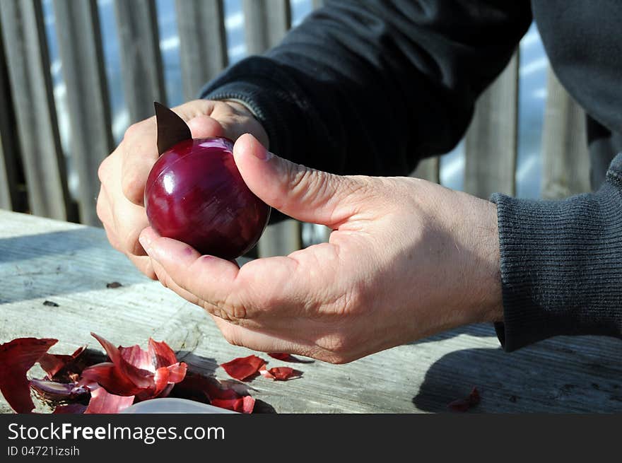 Peeling red onion