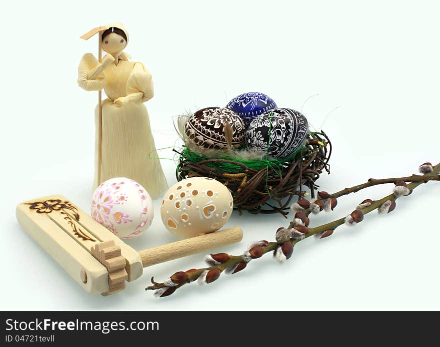 Easter eggs and corn dolls on white background