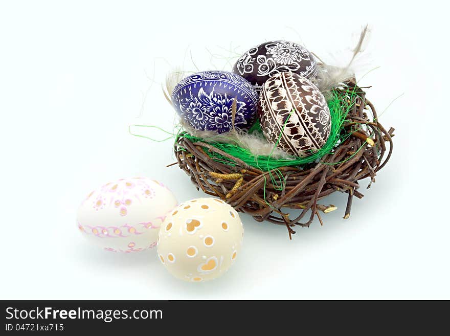 Easter eggs in the nest on a white background