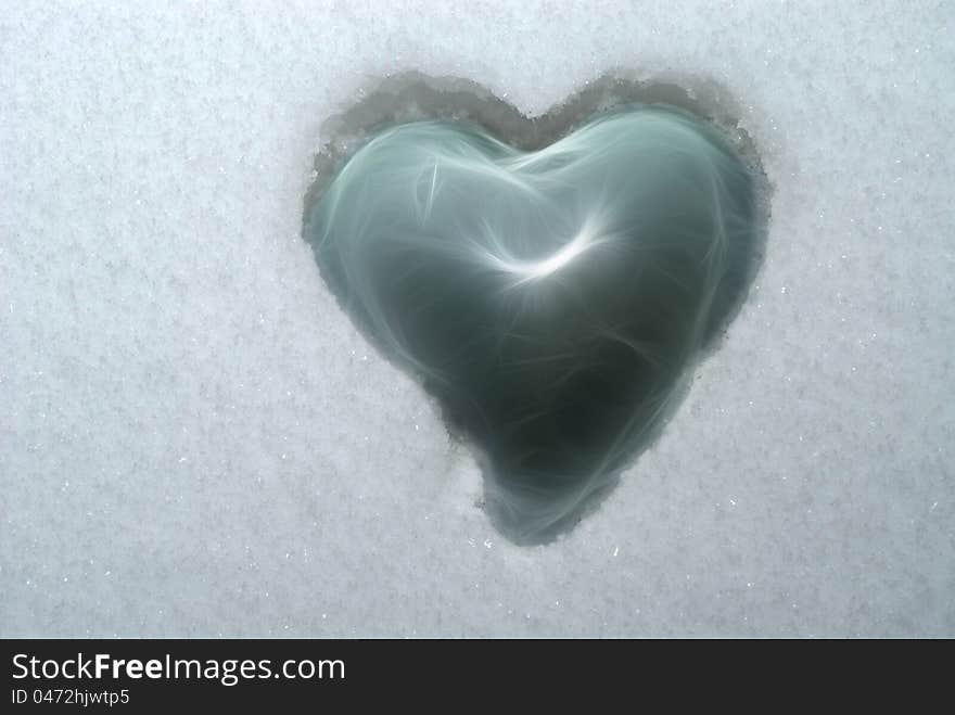 Fragile glass heart embedded in ice cold snow. Fragile glass heart embedded in ice cold snow