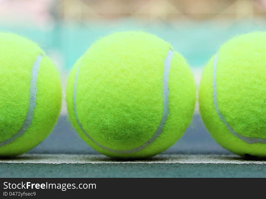 Photo of brand new tennis balls arranged in a row