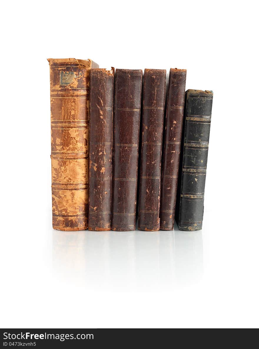 Few old books standing in a row on white background. Clipping path is included