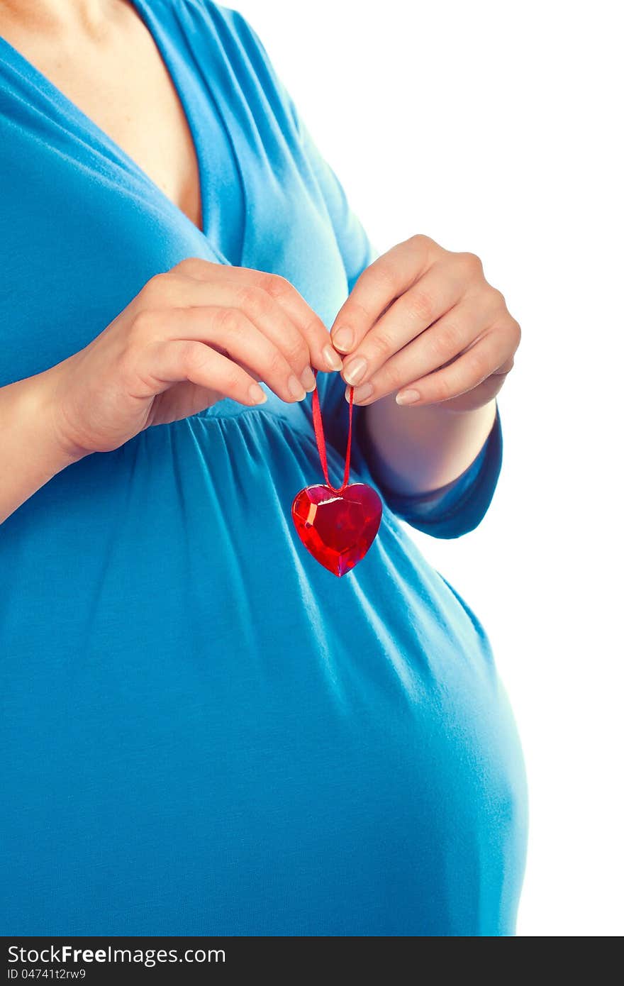 Pregnant woman holding heart over her tummy