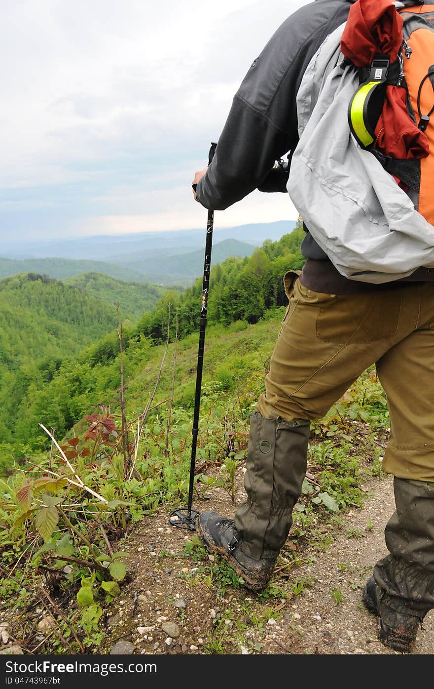 Hiker with backpack in the mountains