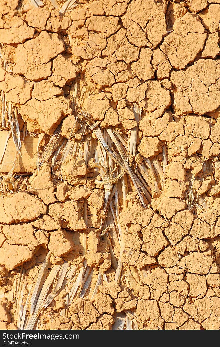 Full frame of grunge clay cliff wall with straw. Full frame of grunge clay cliff wall with straw.