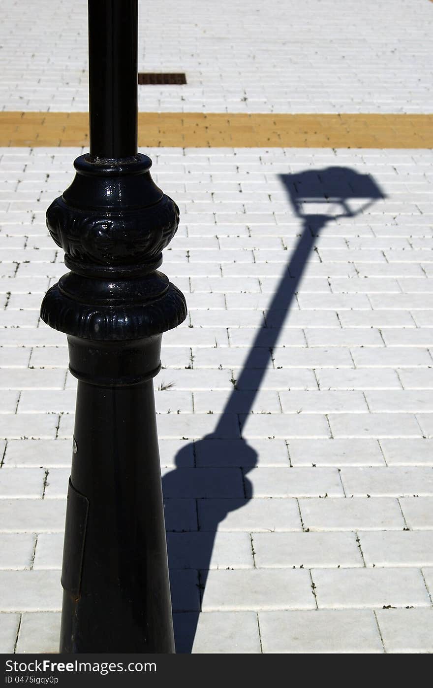 Detail of a street lamp with black shade. Detail of a street lamp with black shade