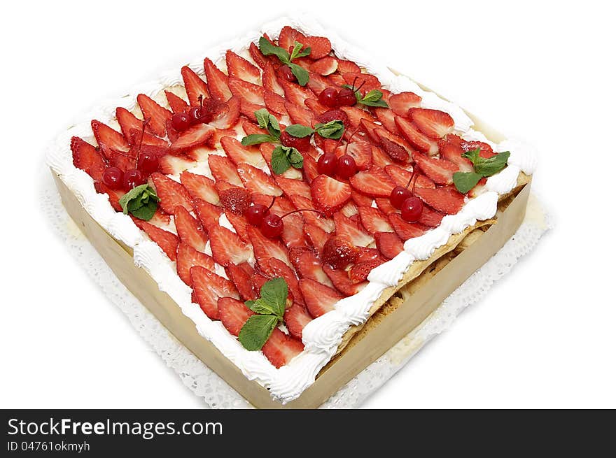 A large strawberry cake on white background